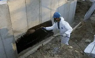 Professional waterproofing the exterior walls of the basement in Scottsdale, AZ