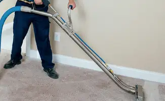Professional operating a liquid removal machine on a carpeted floor in Scottsdale, AZ